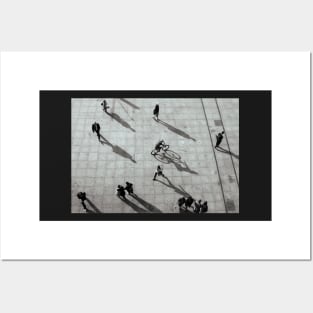 View from above of silhouettes of pedestrians walking in a large concrete plaza. Photo shot at Alexanderplatz, Berlin (Germany). Posters and Art